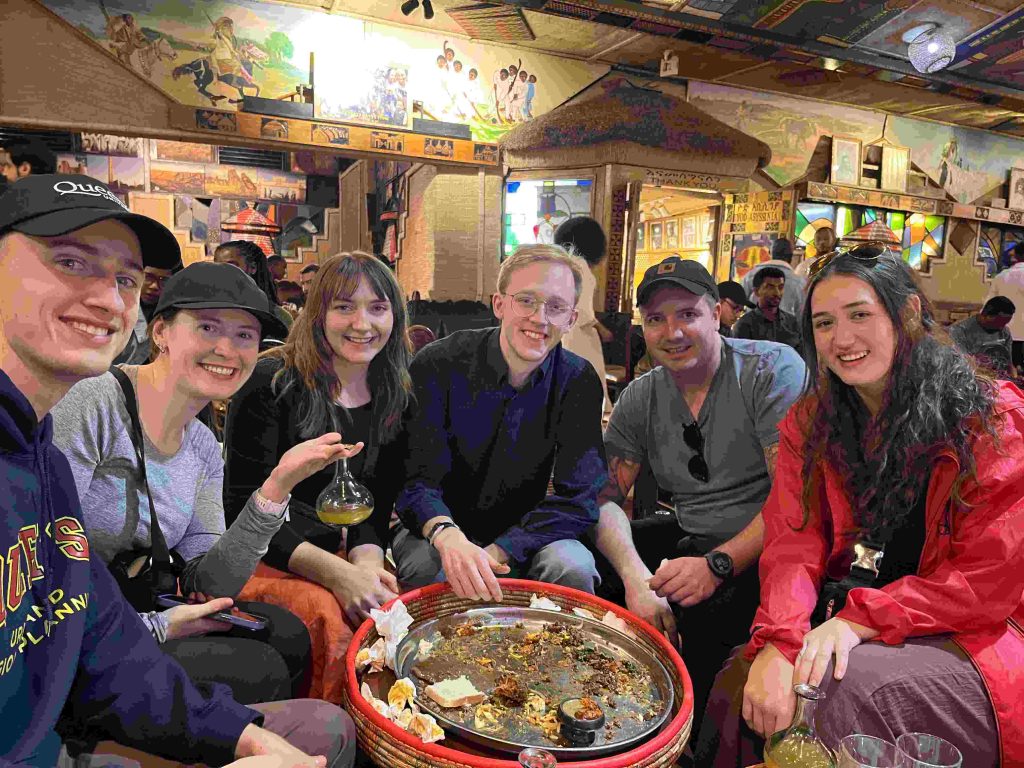 Family enjoying traditional Ethiopian food together during an Addis Ababa tour