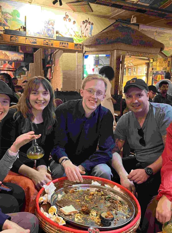 Family enjoying traditional Ethiopian food together during an Addis Ababa tour