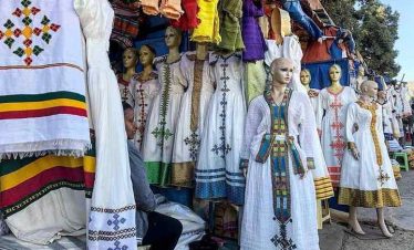 Tourists exploring a traditional clothing shop at Shiromeda during an Addis Ababa souvenir tour