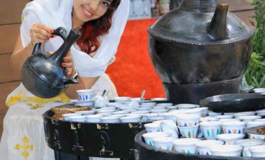Tourist pouring Ethiopian traditional coffee during a cultural experience in Addis Ababa