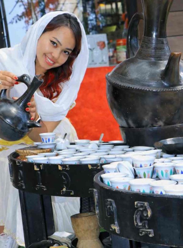Tourist pouring Ethiopian traditional coffee during a cultural experience in Addis Ababa