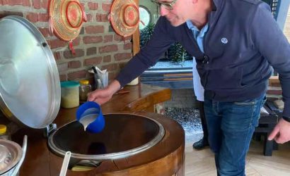 Tourist learning to make injera, traditional Ethiopian flatbread, in Addis Ababa