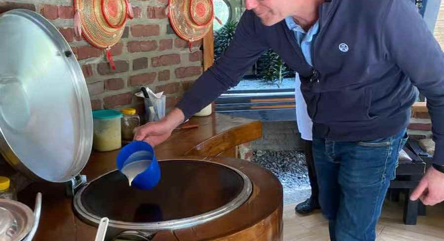 Tourist learning to make injera, traditional Ethiopian flatbread, in Addis Ababa